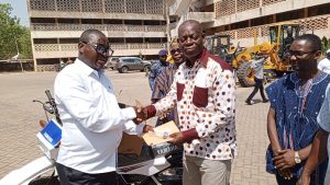 Bolgatanga MCE handing over the motorbike documents to the Bolgatanga District Crime office